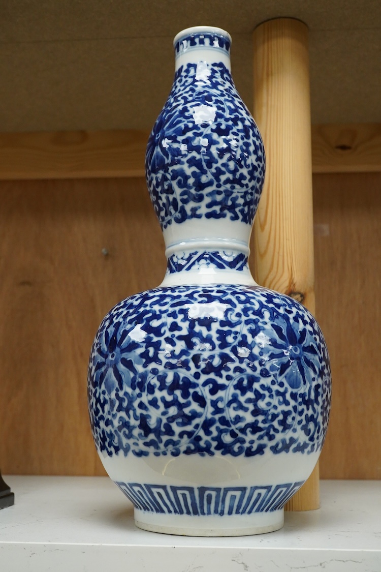 And early 20th century Chinese blue-and-white double gourd shaped vase, blue ring marks to the base, 29cm high
